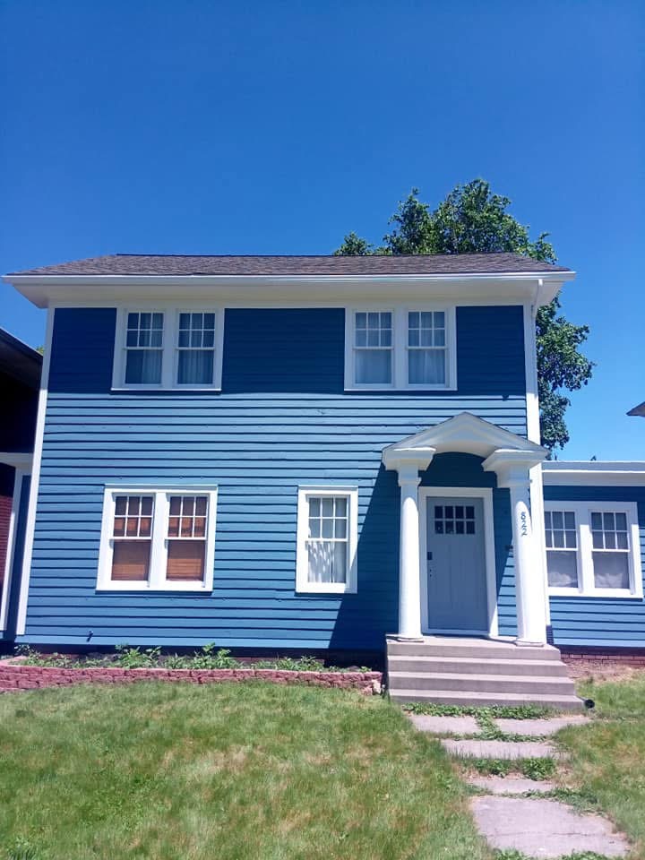 Blue two-story exterior after painting by Shields Painting