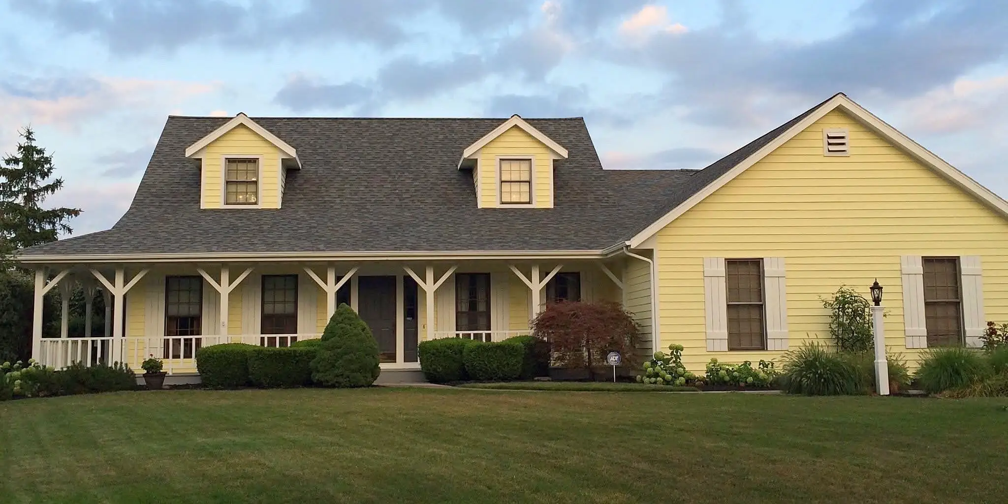 Yellow home exterior painting project by Shields Painting